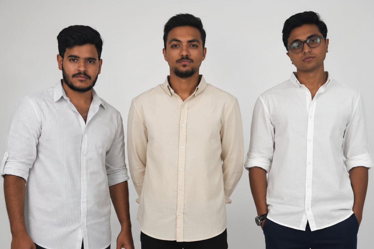 Three men standing side-by-side wearing white and cream button-down shirts, photographed against a neutral light gray studio background.